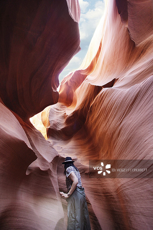 行走在美国亚利桑那州羚羊峡谷的女子图片素材