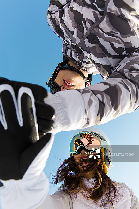 三个年轻男女团结一起伸手加油准备滑雪比赛图片素材