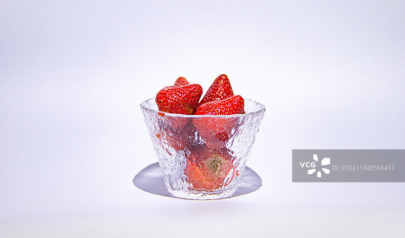 冰状透明锤纹日式手工玻璃杯里装着几颗草莓镜头图片素材