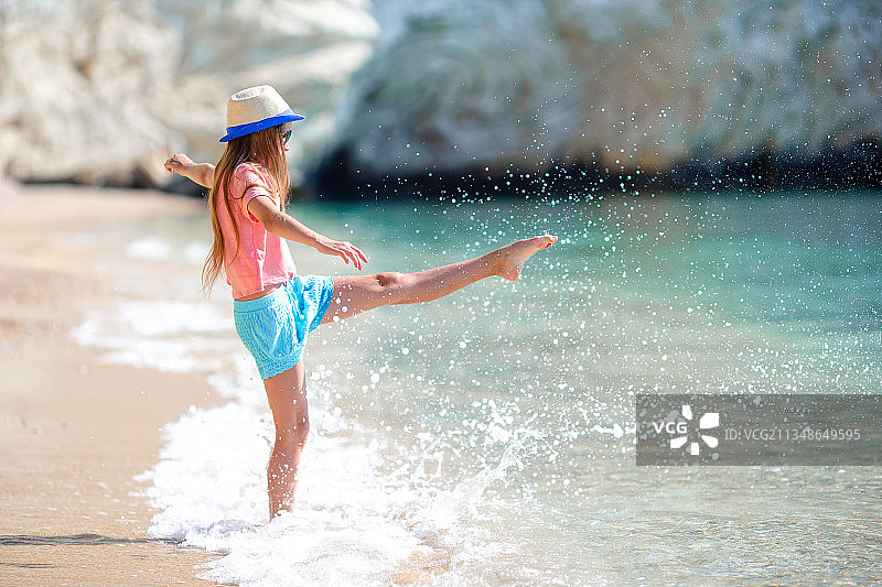 年轻女孩享受着家庭度假的海滩图片素材