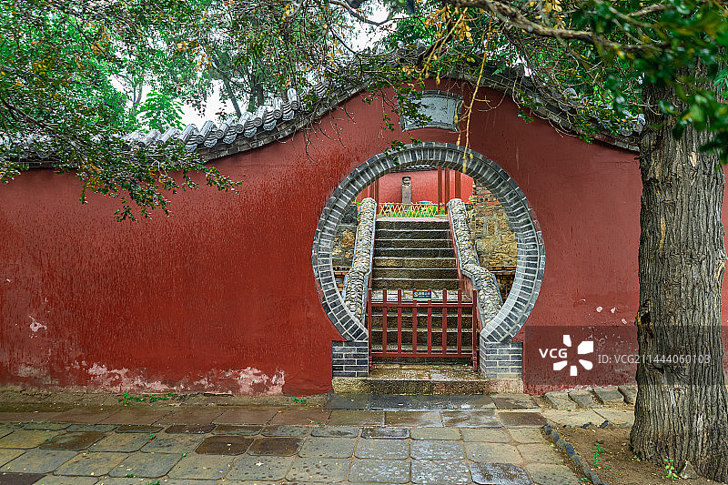 中国山东省泰安市泰山旅游风景区著名景点，普照寺寺庙庭院的红色围墙和石头桌子椅子，户外白昼无人图像摄影图片素材