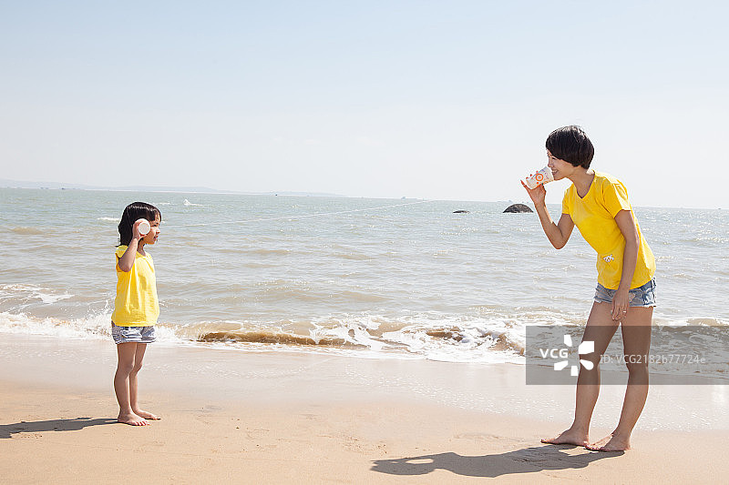 妈妈和女儿在沙滩上玩耍嬉戏图片素材