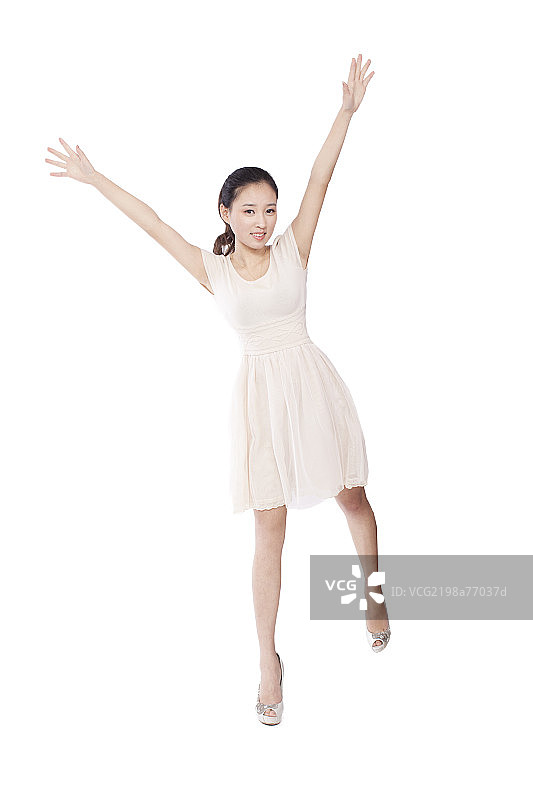 Young woman standing with arms stretched图片素材