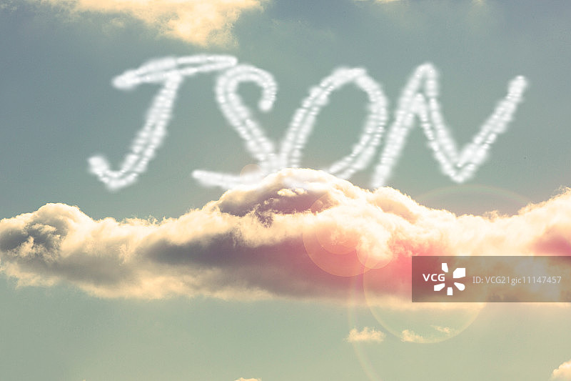 单词json与明亮的蓝天和云图片素材