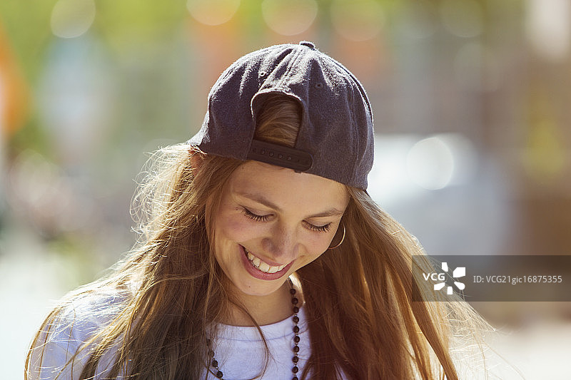 一个戴着棒球帽的年轻女子的肖像图片素材