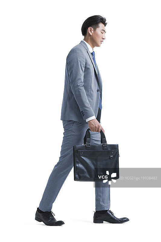 疲倦的年轻商务男子拿着公文包去上班图片素材