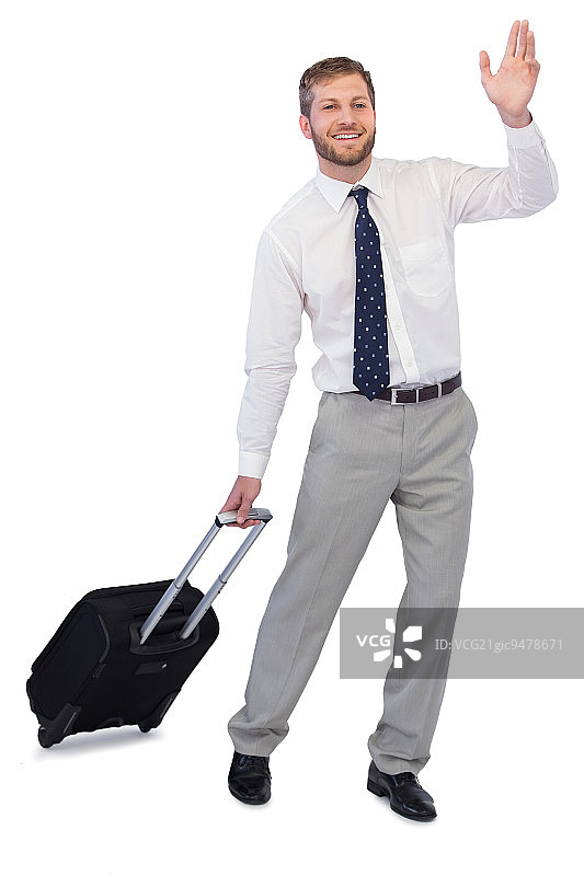 帅气的商人提着行李箱在白色背景下挥舞图片素材