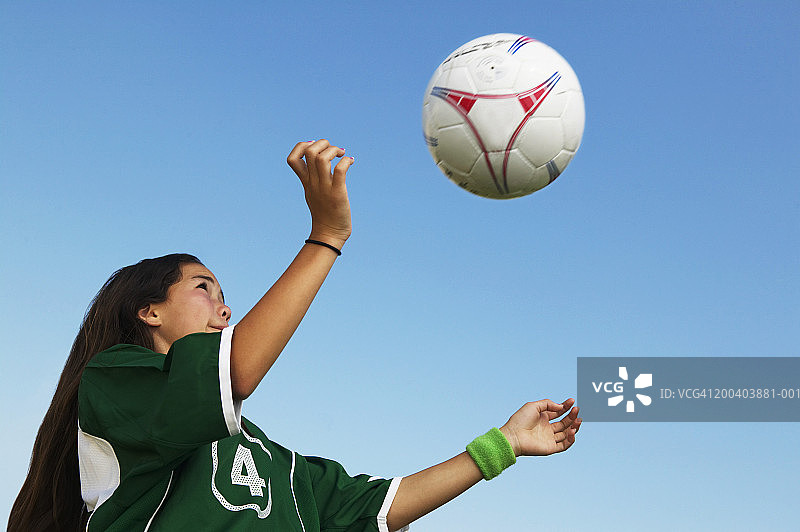 女足球运动员(11-13)头球，低角度视野图片素材