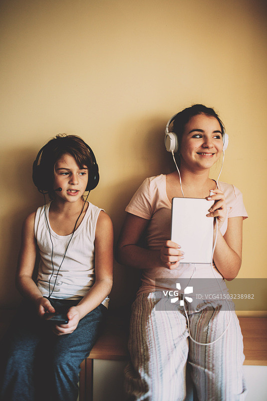 弟弟和妹妹在听音乐图片素材