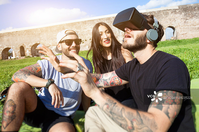 朋友们在公园户外玩VR耳机图片素材