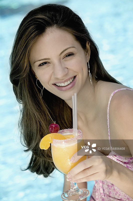 一个年轻女子拿着一杯果汁的肖像图片素材