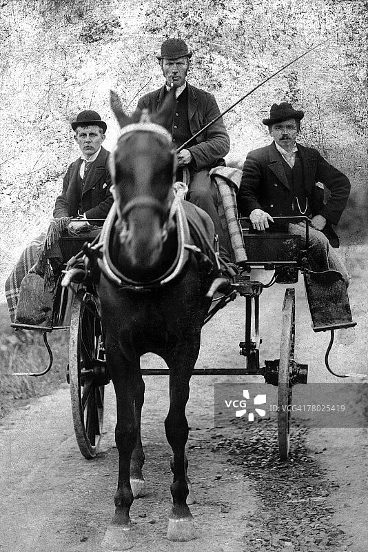 三个穿着西装戴着礼帽的男人坐在由一匹马拉着的双轮马车上。车夫手里拿着长鞭。左边的人是老威廉·克罗斯先生。图片素材