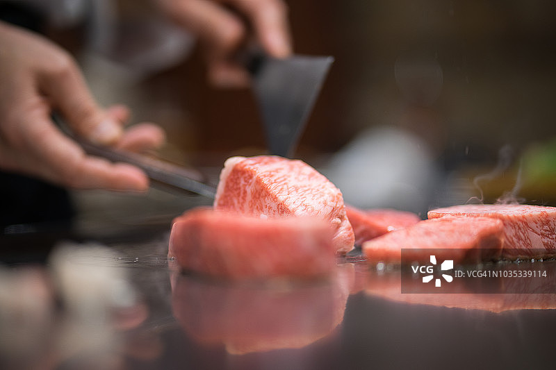 日本厨师为客户烹制铁板烧风格的牛肉图片素材