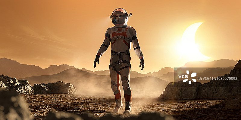 火星宇航员行走在岩石火星景观在月食期间图片素材