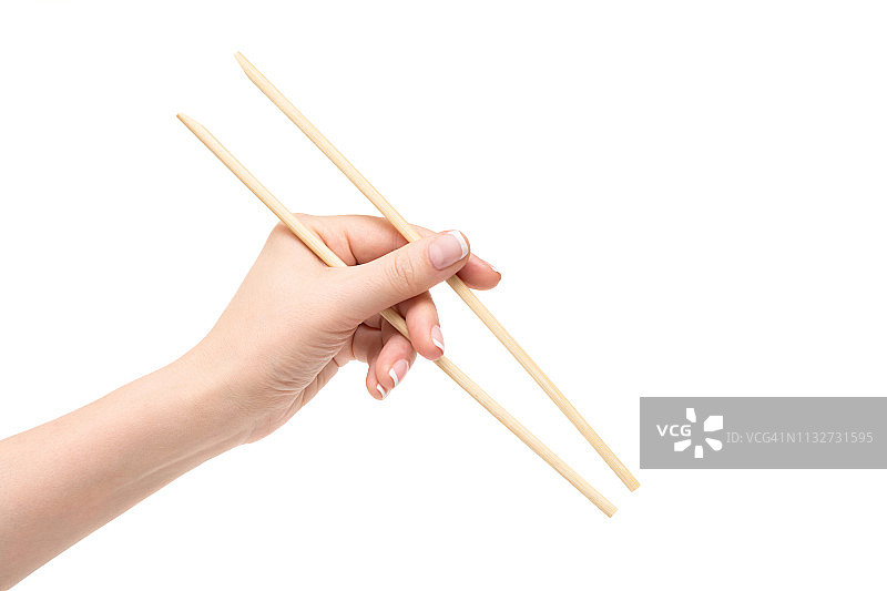 孤立的女性手拿筷子在一个白色的背景。图片素材