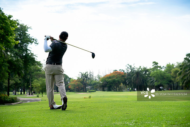 在暑假期间用球杆打高尔夫球的高尔夫球手。图片素材