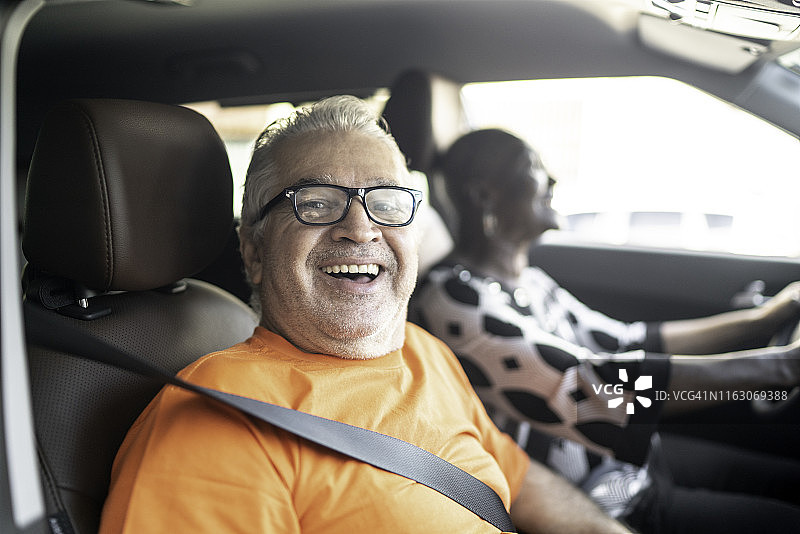 一位老人坐在汽车副驾驶座上的肖像图片素材