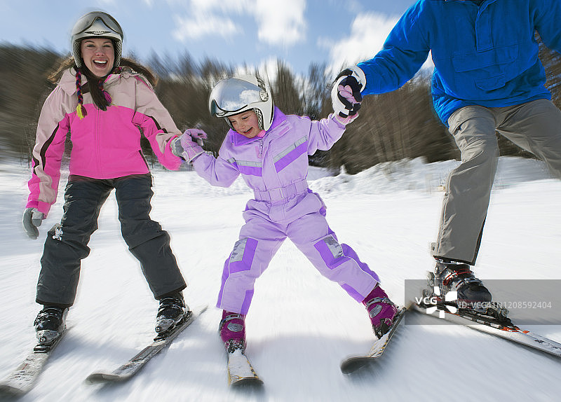 和父母一起学滑雪的女孩图片素材