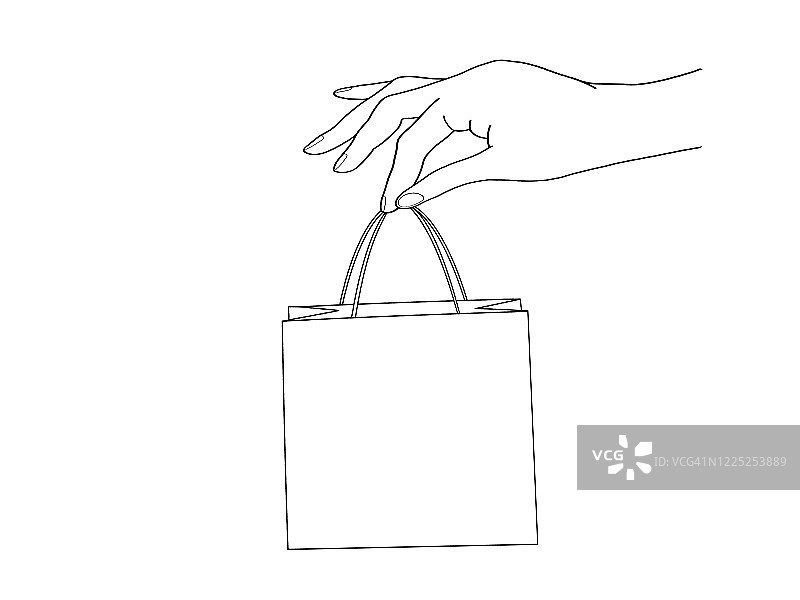 一个女人的手拿着一个购物袋图片素材