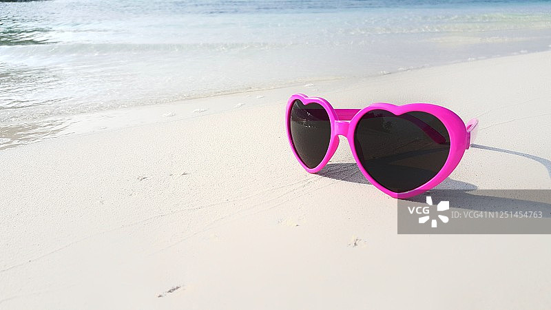 海滩夏日度假概念，太阳镜躺在马尔代夫的白沙上图片素材