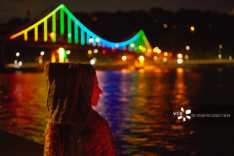 一名年轻的白人女子在基辅市中心的发光人行桥旁休息。图片素材