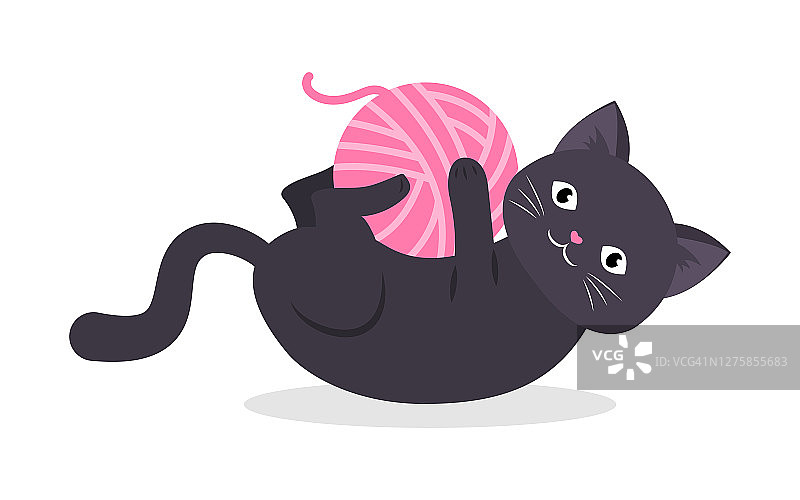 黑猫玩粉红色的线索编织。图片素材