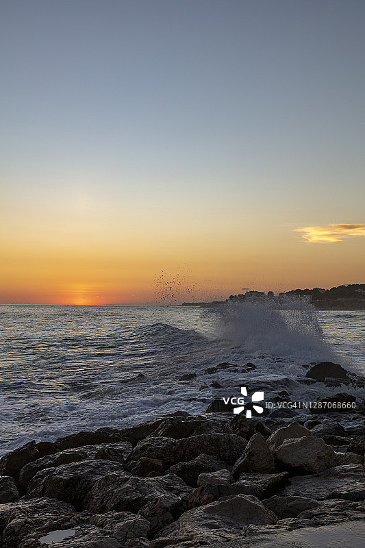 日落时海边的岩石图片素材