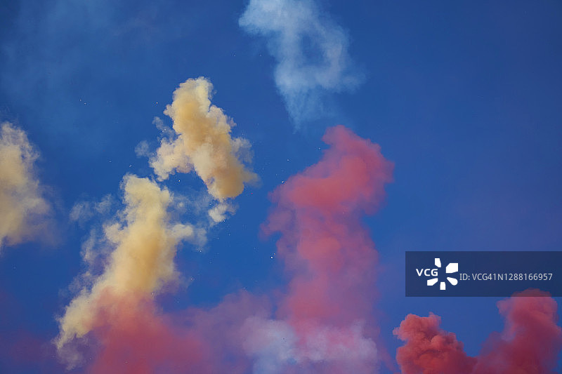 彩色粉末烟雾在天空中燃放了一天的烟花。图片素材