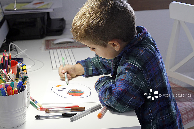 儿童在书桌上画画的特写图片素材