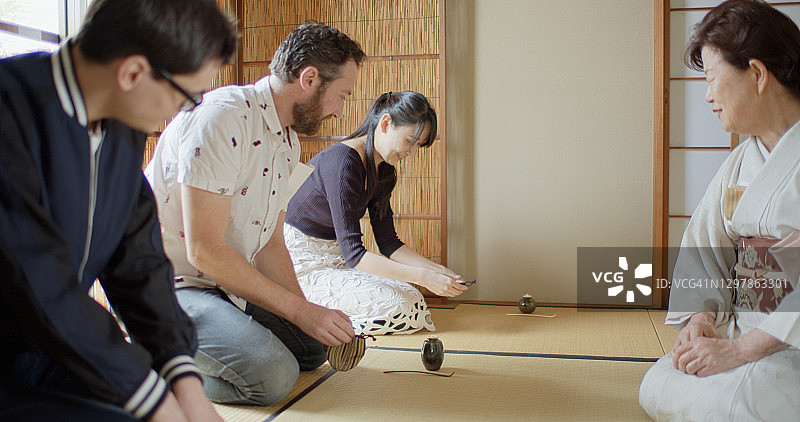 白种游客在日本接受传统茶道的指导图片素材