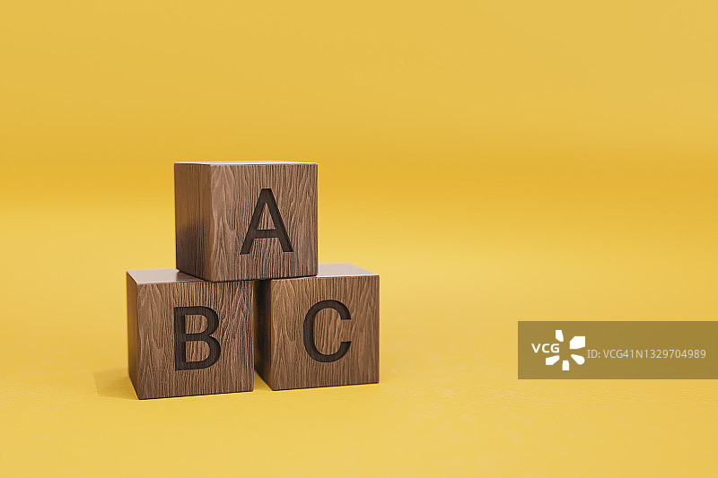ABC木制文本字母块在黄色背景图片素材