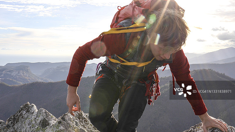 登山运动员爬上山顶图片素材