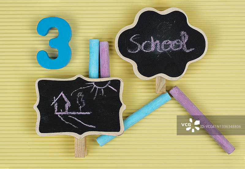 儿童绘画，文字学校和玩具车在小黑板和彩色粉笔在黄色背景图片素材