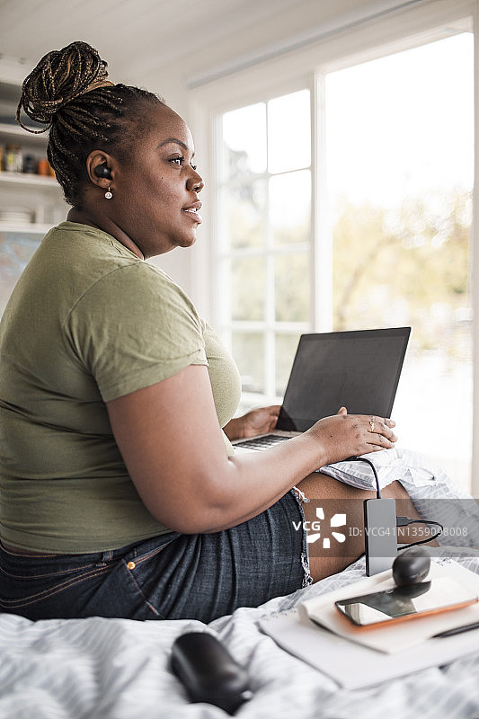 女性自由职业者在小屋中用笔记本电脑远程工作图片素材