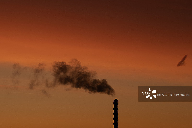 工业工厂的烟囱向大气中排放蒸汽图片素材