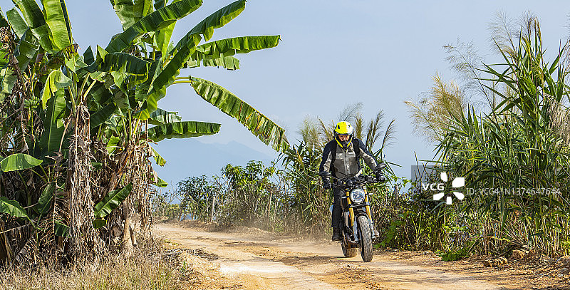 一名男子在泰国北部骑着他的扰频器式摩托车图片素材