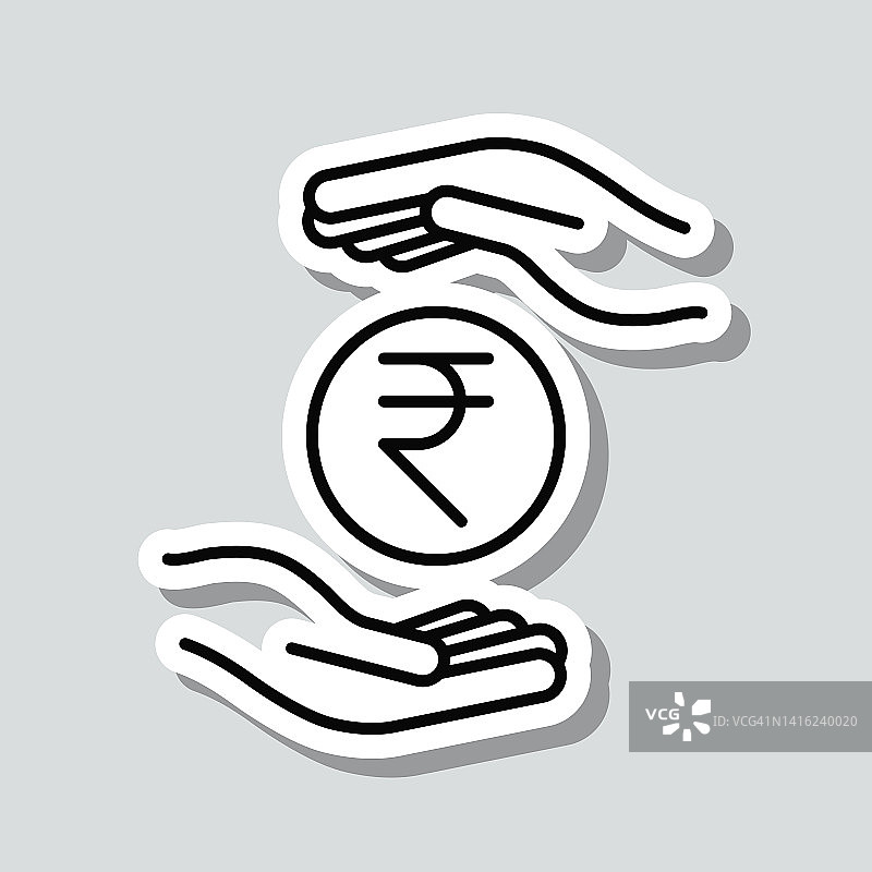 双手之间的印度卢比硬币。图标贴纸在灰色背景图片素材