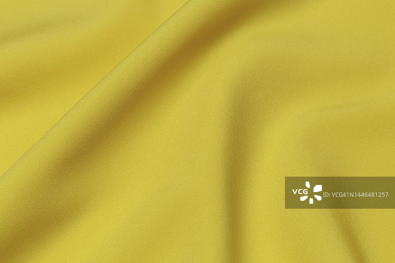 黄色面料面料面料涤纶质地和纺织背景。图片素材