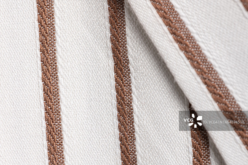 纺织背景与棕色条纹。织物纹理图片素材