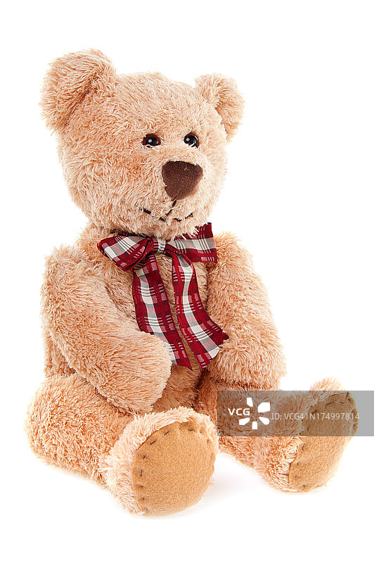 可爱的泰迪熊玩具坐着，孤立的白色图片素材