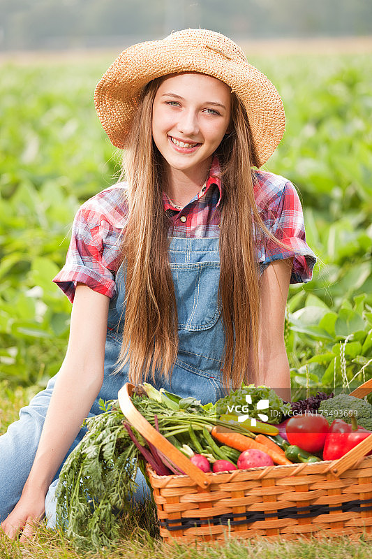 田边有蔬菜的农家女孩图片素材