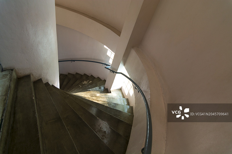 弯曲的楼梯，现代建筑细节的俯视图，精致的当代办公/公共建筑内部。图片素材