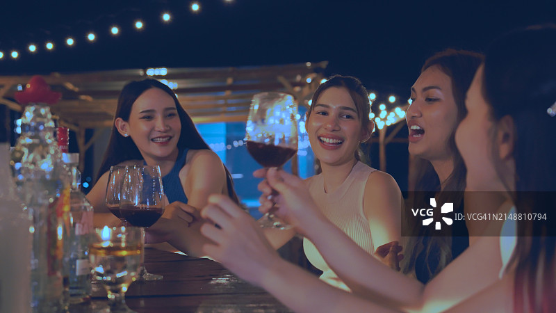 一群迷人的女人在豪华的酒吧里享受夜生活，聚会和喝鸡尾酒。快乐的女性朋友庆祝节日聚会在夜总会在城市图片素材