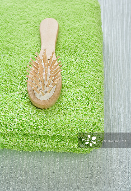 绿色毛巾上的木梳子图片素材