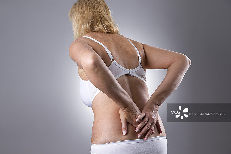 背痛的女人。人体的疼痛图片素材