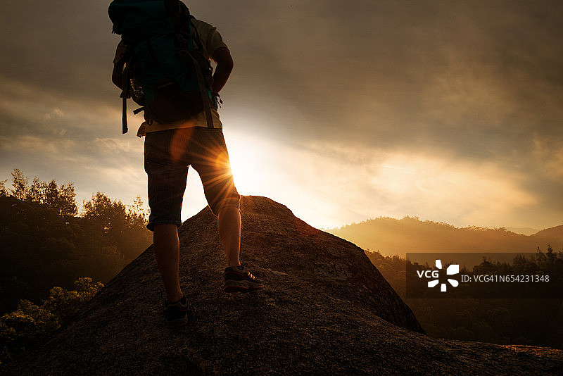 日落时站在山上的人的低处图片素材