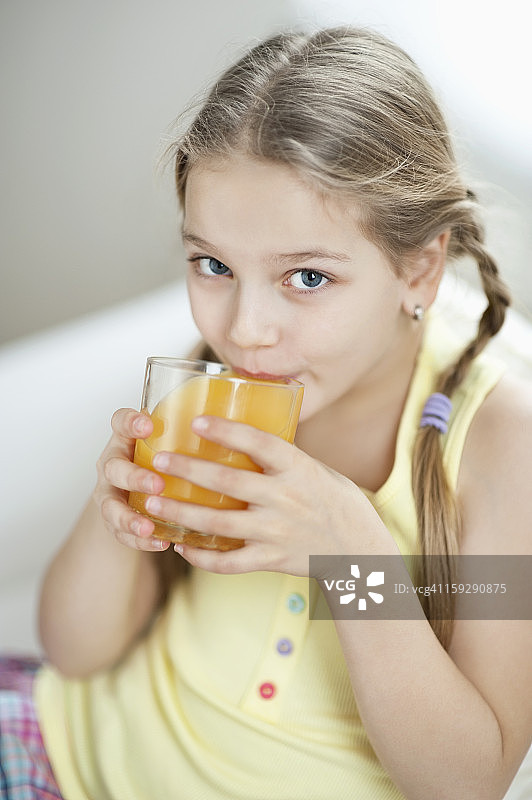 小女孩喝橙汁的画像图片素材