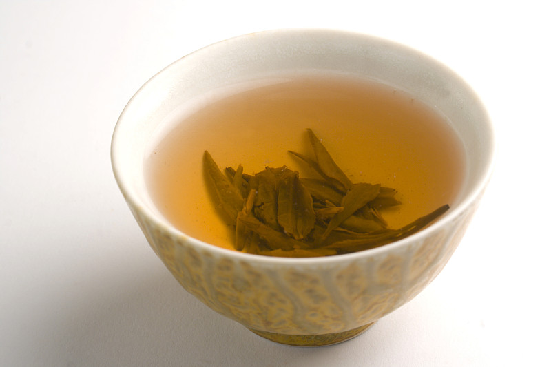 白底上分离的杯中的中国热绿茶图片下载