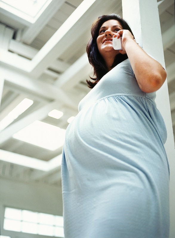 一个孕妇的低角度侧面轮廓通话图片下载