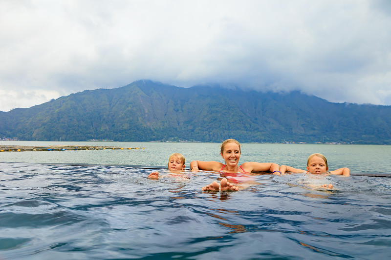 巴图尔火山温泉的幸福家庭。图片素材